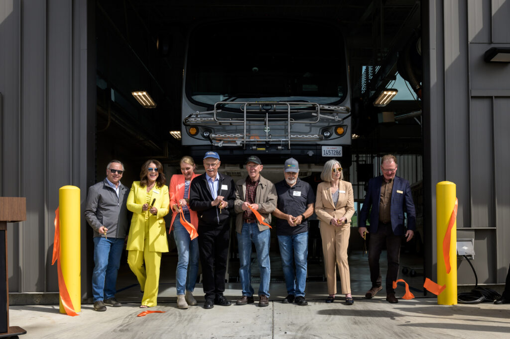 Members of the NVTA Board celebrate after cutting the ribbon on the new Vine Transit Maintenance Facility. (Justin Lopez Photography)
