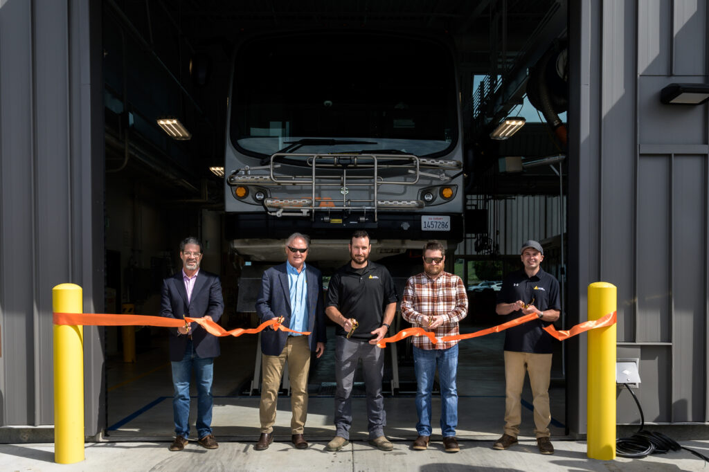 Alten Construction, which built the new Vine Transit Maintenance Facility, celebrate with a ribbon cutting. (Justin Lopez Photography)