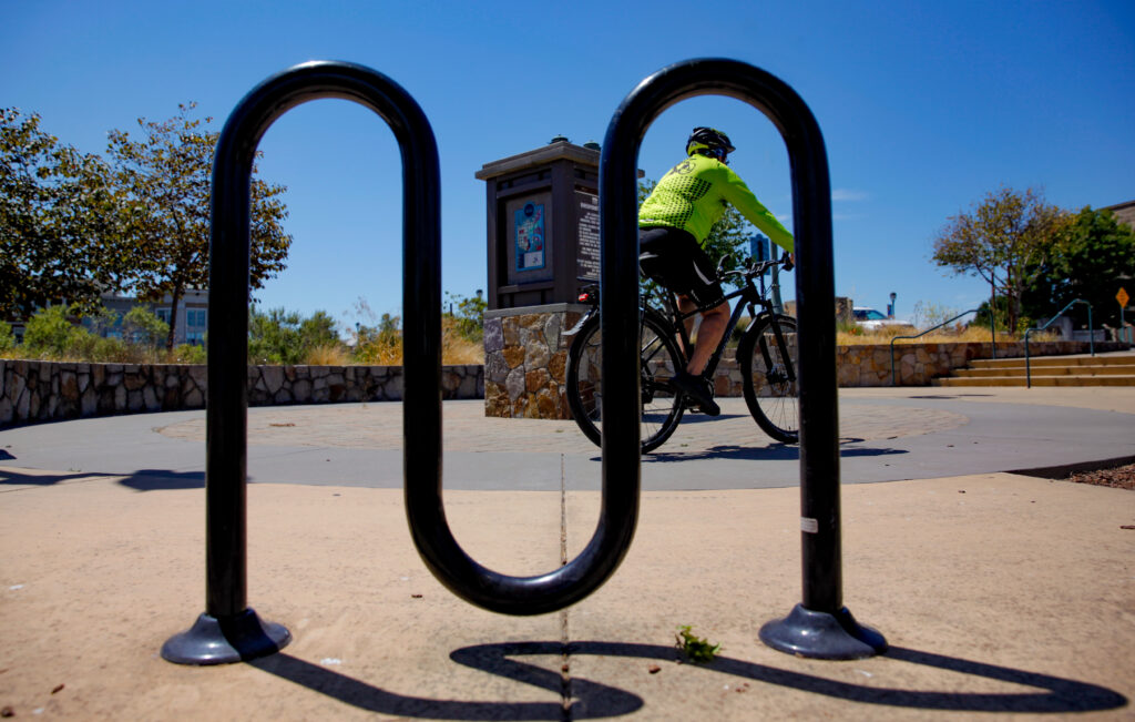 A cyclist passes bike parking on the Napa Valley Vine trail in downtown Napa. 